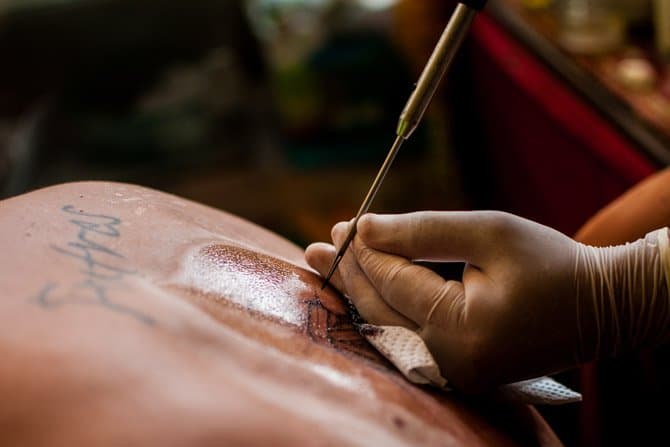 Sak Yant bamboo tattoo by a monk in Thailand