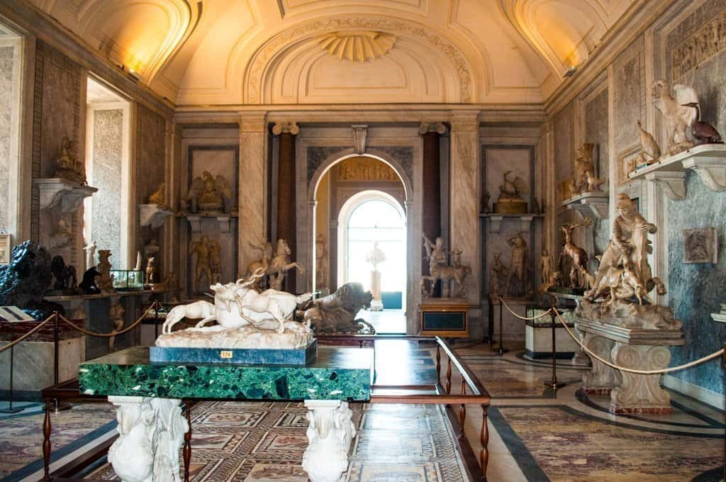 A room full of statues and priceless artwork in the Vatican Museum