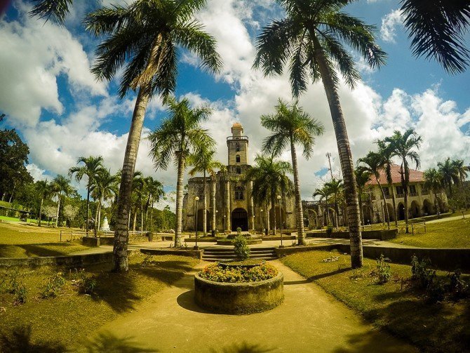 Exterior of a Spanish style church with palm trees in front in Bohol, Philippines