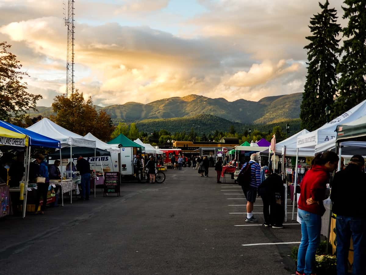 Farmer's market set up along a road with mountains in the background