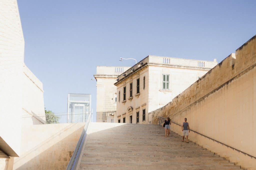 street view of stairs and cream colored buildings in Malta