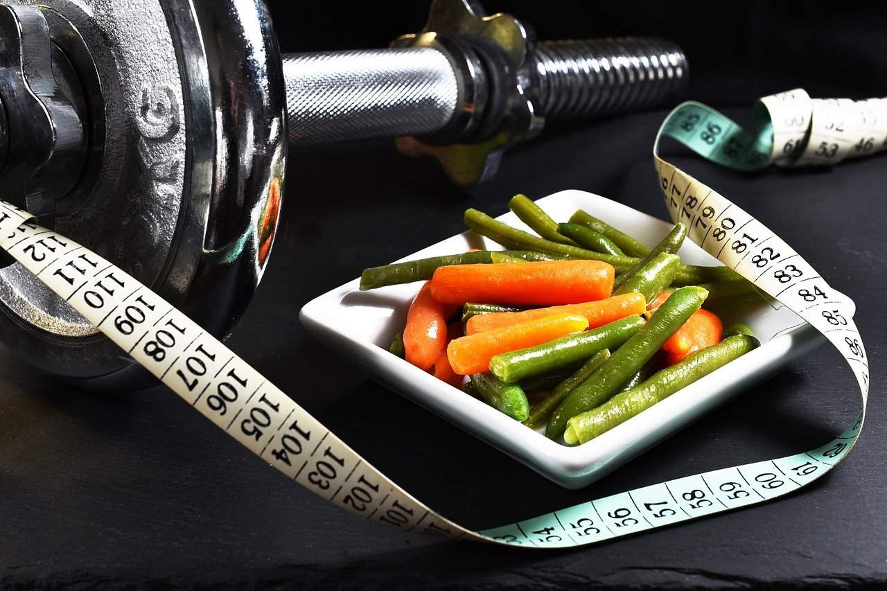 Barbell with plate of vegetables for staying healthy when stuck at home