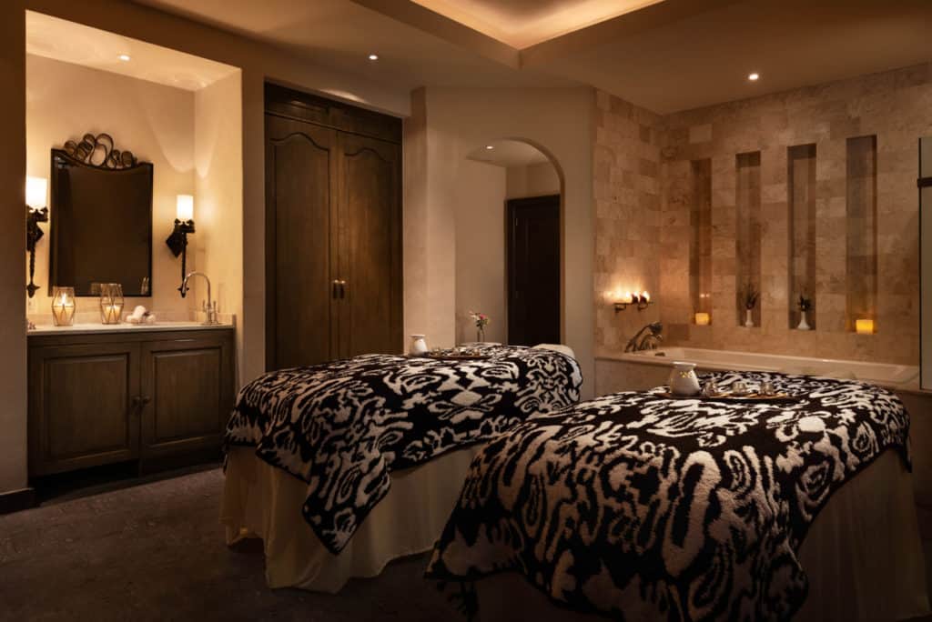 Dimly lit room with massage beds in a spa