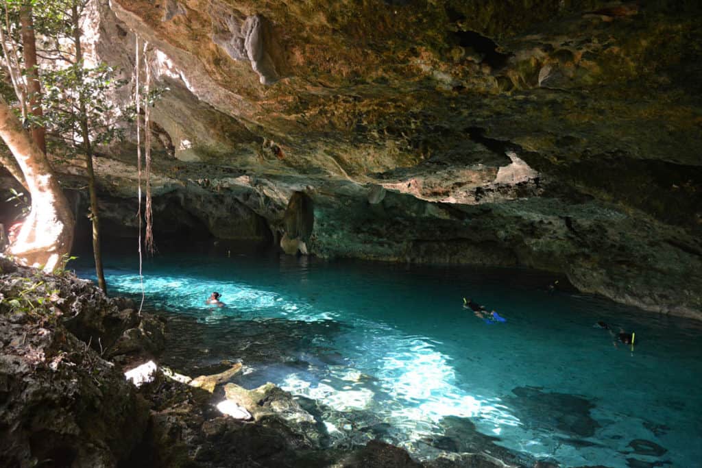 Peoel snorkeling in a cave Cenote in Mexico